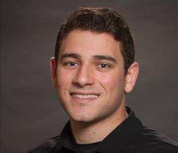 White male with black jacket and black hat.