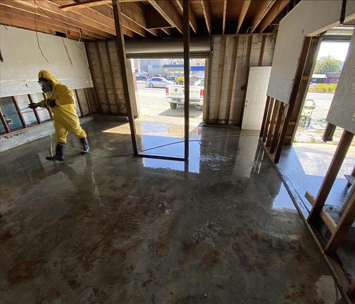 Man cleaning garage surfaces